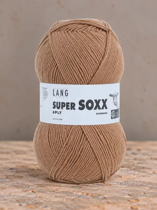 A skein of solid tan Lang Yarns Super Soxx 6 ply – kestävä sukkalanka villasta with a white label.