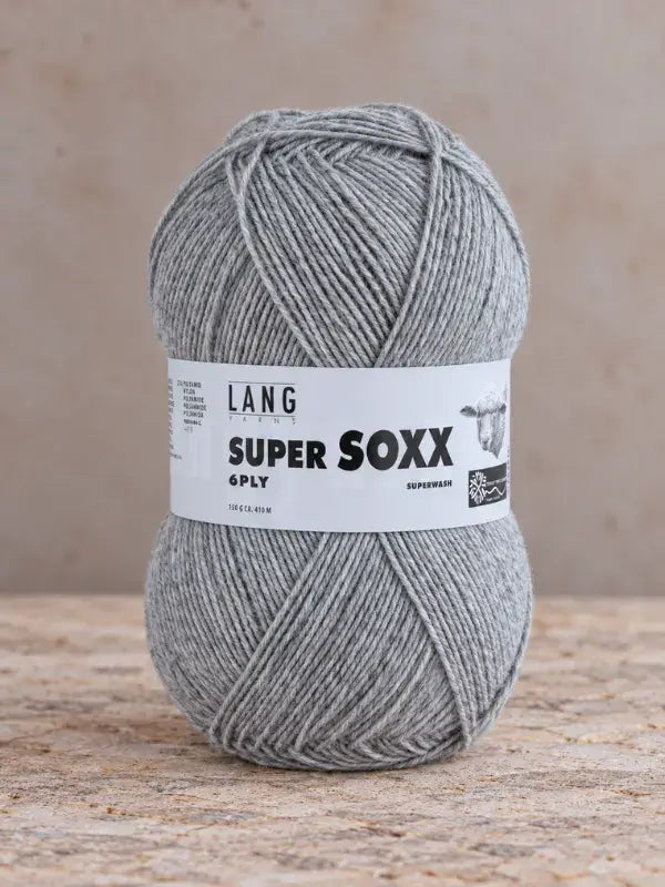 A ball of grey Lang Yarns Super Soxx 6 ply – kestävä sukkalanka villasta with a product label featuring a sheep illustration.