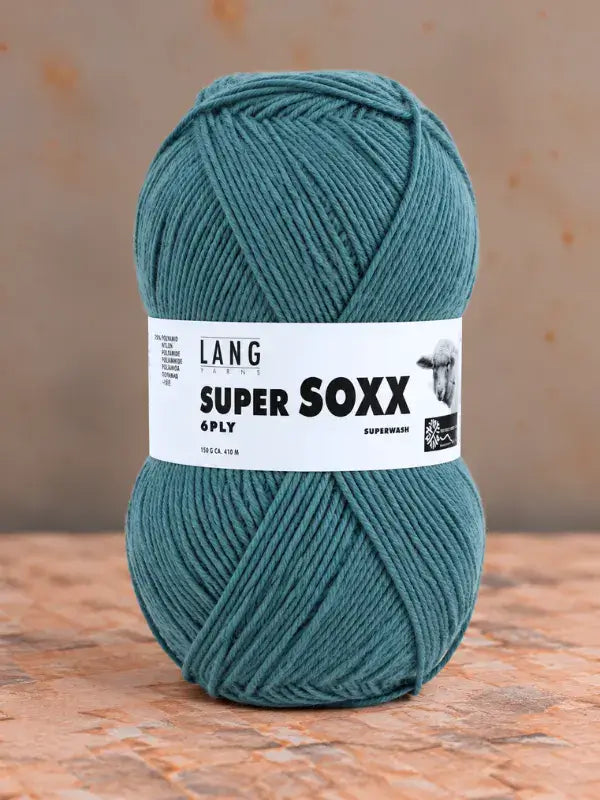 A ball of teal Lang Yarns Super Soxx 6 ply – kestävä sukkalanka villasta yarn with a label displaying the text SUPER SOXX 6PLY.