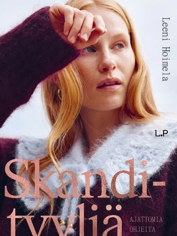 A woman with long red hair wearing a fuzzy maroon and gray sweater gazes into the distance, shielding her eyes with her hand. Text on the image reads “Skandityylejä” and “Leeni Hoimela – Skandityyli, Ajattomia ohjeita nykyneulojalle,” embodying true Nordic Chic inspired by designs from this neulekirja (knitting book).