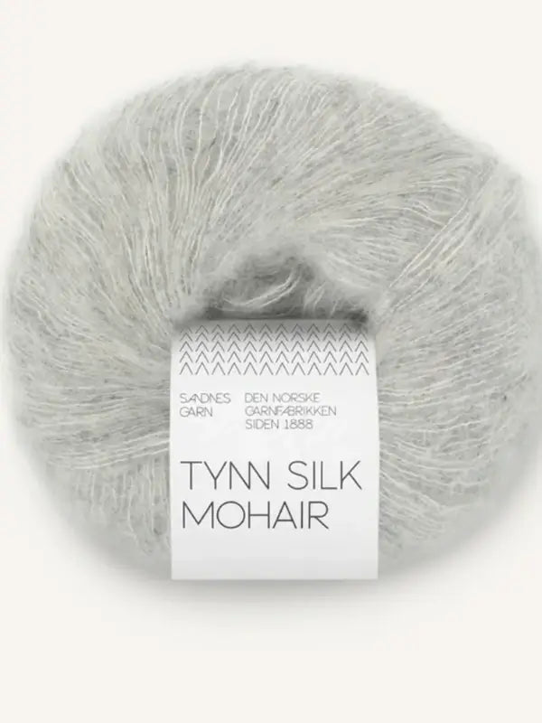 A ball of light gray Sandnes Garn Tynn Silk Mohair yarn with a white label featuring the brand and product name in black text.