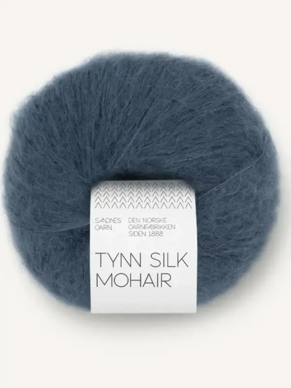 A ball of Sandnes Garn Tynn Silk Mohair in dark blue, featuring a white label with the brand and product name in black text. This luxurious silk-mohair yarn is perfect for delicate knits.