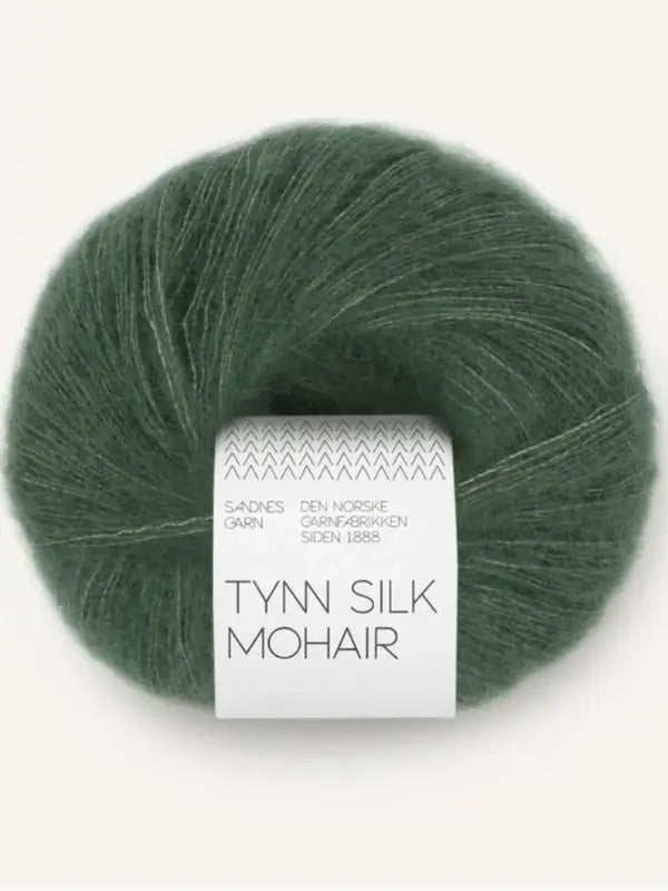 A ball of green Sandnes Garn Tynn Silk Mohair yarn, wrapped with a white paper label around the center.