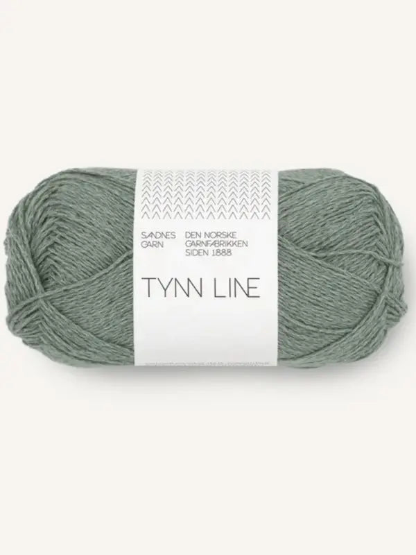 A skein of Sandnes Garn Tynn Line in light sage green, featuring minimalist white packaging with black text—an ideal fingering weight kesäneulelanka for your next summer project.